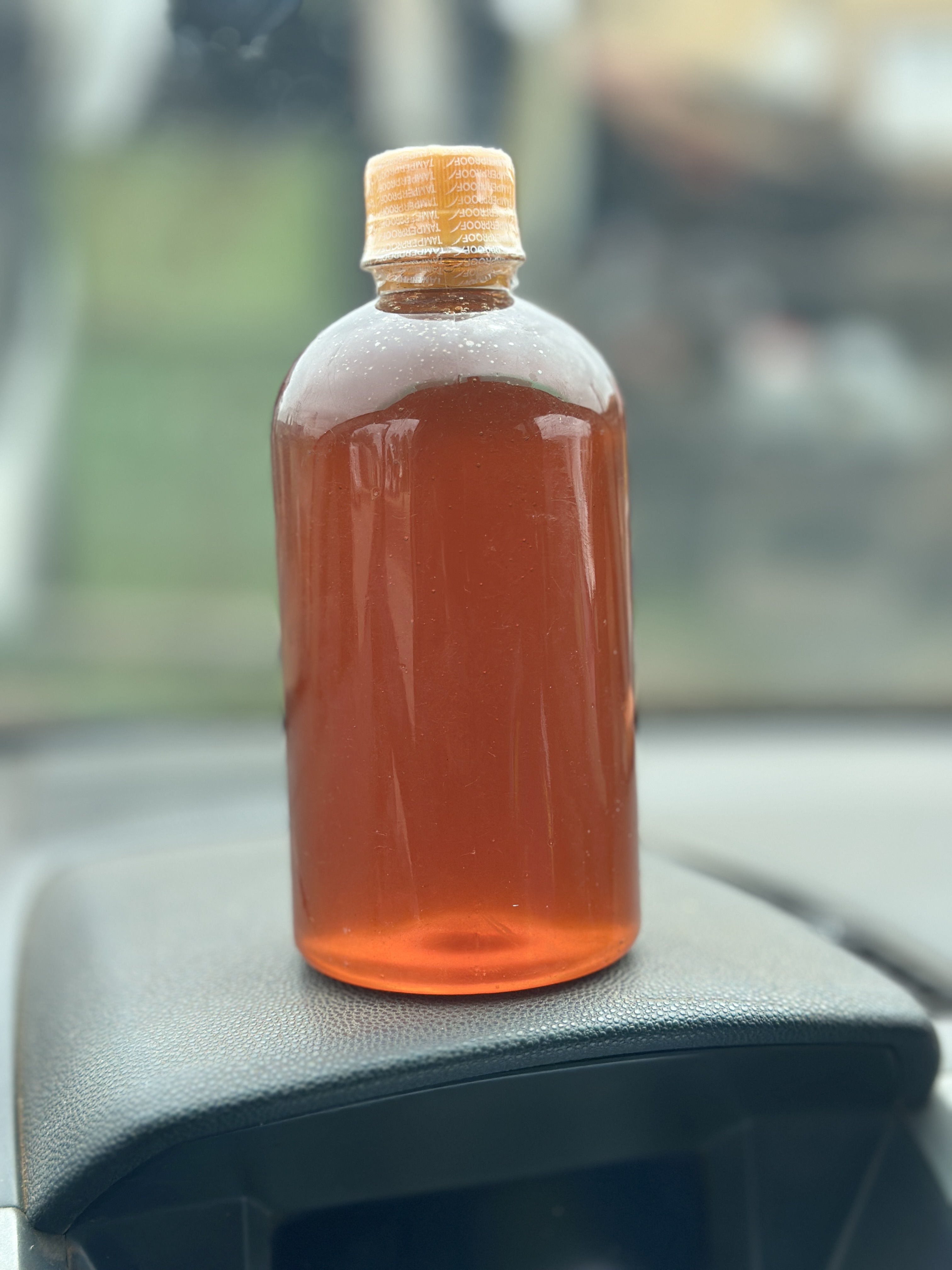 Half litre bottle of amber raw honey